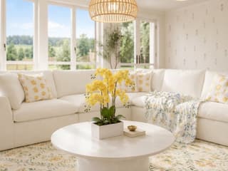 cottage-sunroom-with-white-sectional-and-floral-rug.jpg