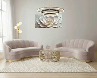 Living room featuring two pink sofas, patterned rug, and a floral art piece.