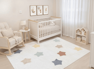 Nursery with white crib, rocking chair, star rug, & framed teddy bear art.