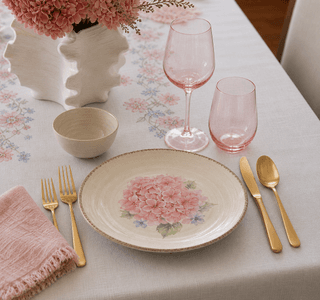 Close-up of floral porcelain plate with gold cutlery and blush napkin