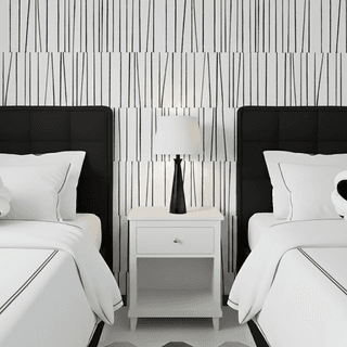 Bedroom with two beds, black headboards, white linens, black-and-white wallpaper, and a white nightstand with a lamp.