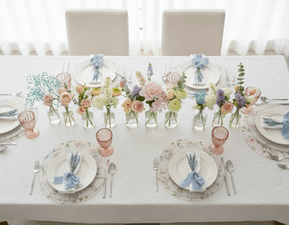 Overhead shot of a table set for four with floral accents and place settings.