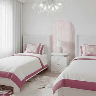 Bright bedroom with two twin beds, butterfly pillows, and pink accents.