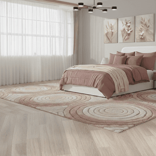 Bedroom with white bed, mauve bedding, patterned rug, and floral wall art.